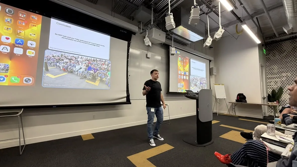 Oleg Sotnikov speaking on stage at a Google Gemini event at Google's Sunnyvale campus, on privacy and personal space in the era of vibe coding and modern LLMs