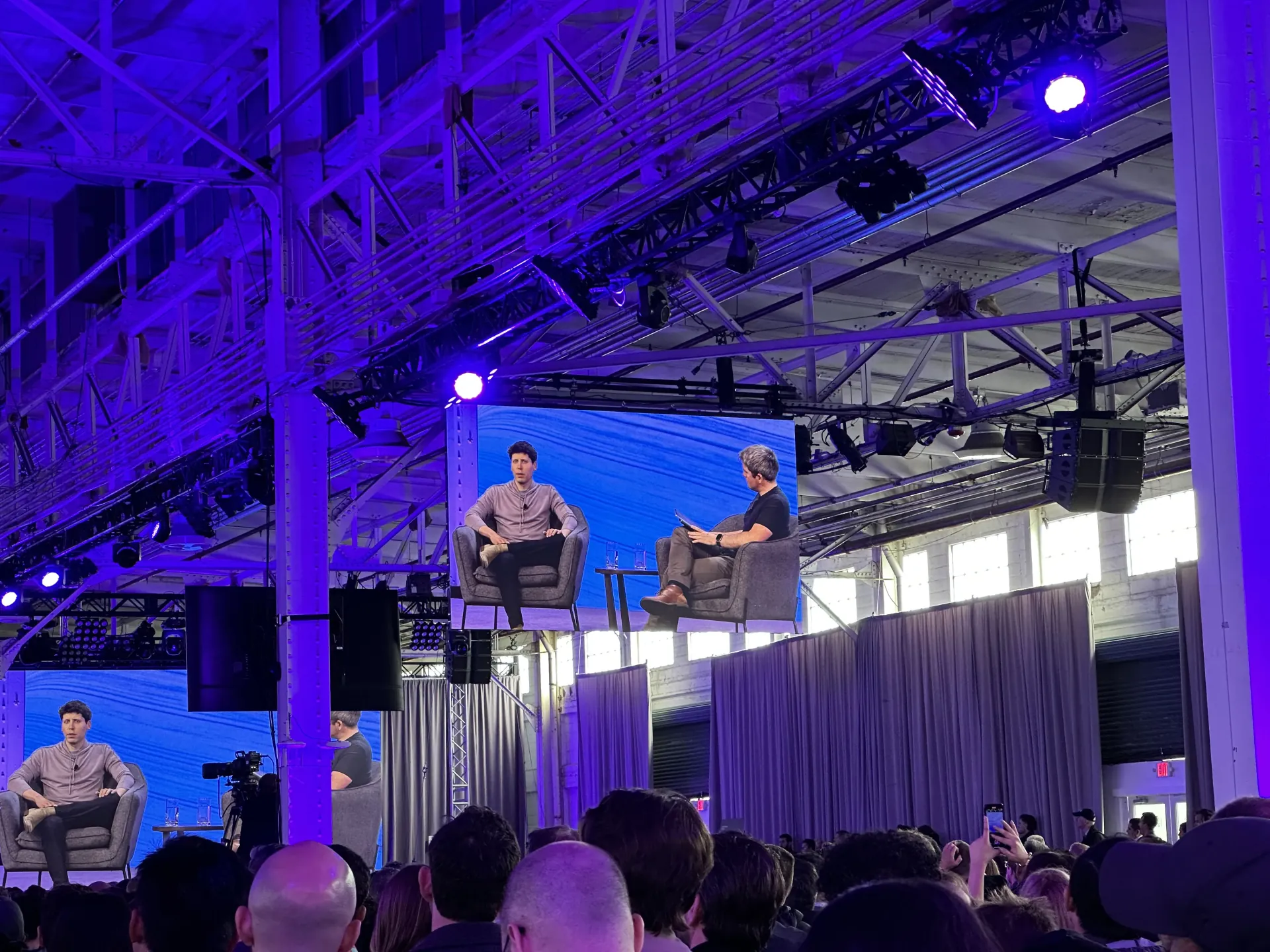 Sam Altman, CEO of OpenAI, on stage at an OpenAI keynote attended by Oleg Sotnikov