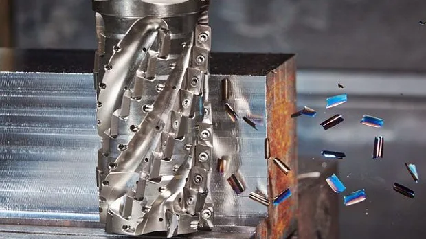 A milling cutter working a steel block